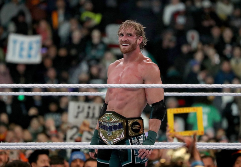 a man in a wrestling ring with a world heavyweight championship belt