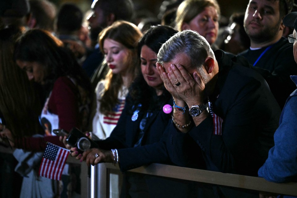 A Harris supporter holds his head in his hands