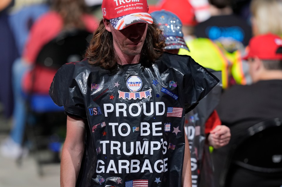 Supporters wearing garbage bags arrive for a Republican campaign rally