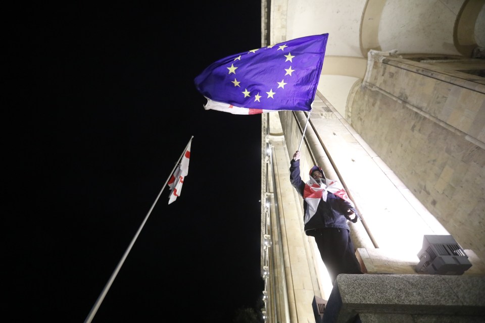 A protester waving an EU flag outside of Georgia’s parliament