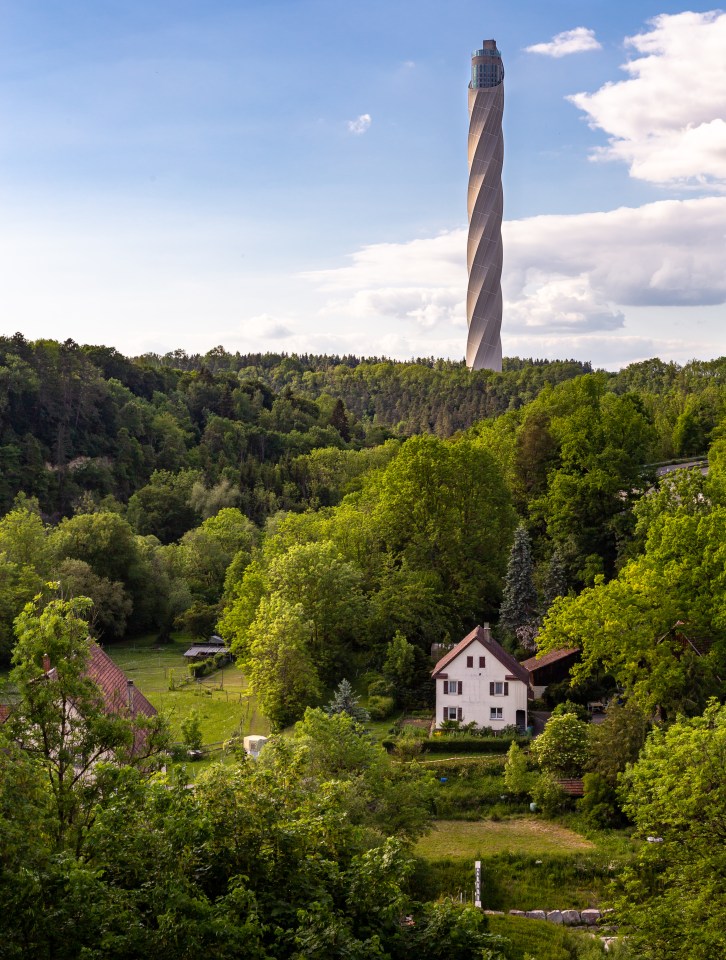 The elevator test tower sits near a quiet forest town