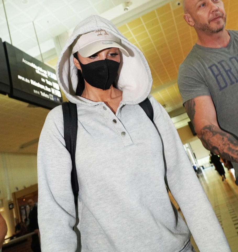 Tulisa tried to completely disguise herself as she landed in Australia