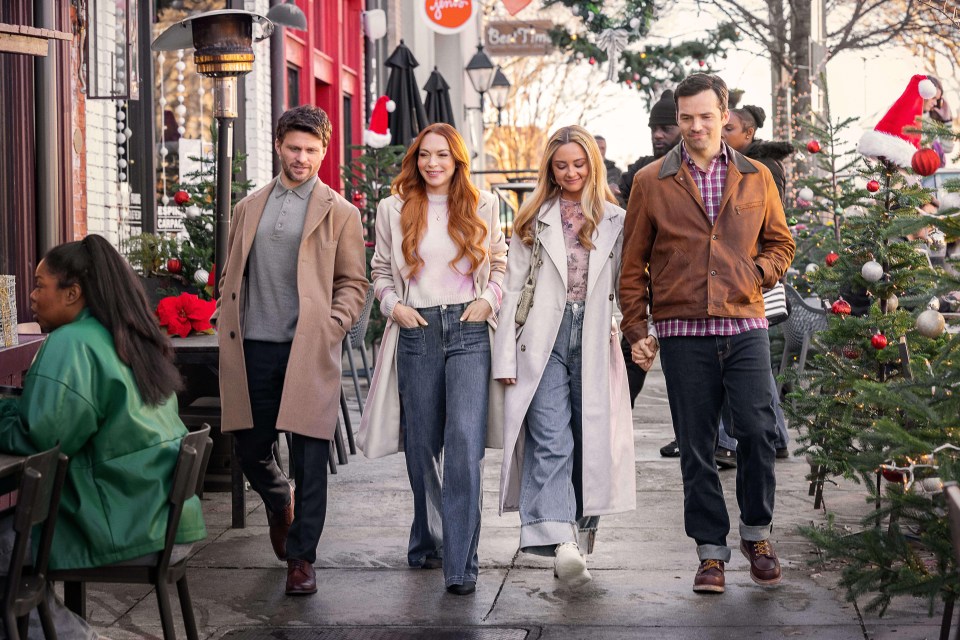 a group of people are walking down a sidewalk in front of a sign that says jerry 's