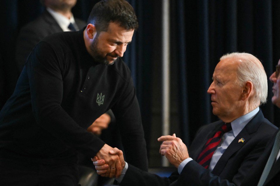 Zelensky shakes hands with US President Biden who has now permitted Ukraine to fire its long-range missiles into Russia territory