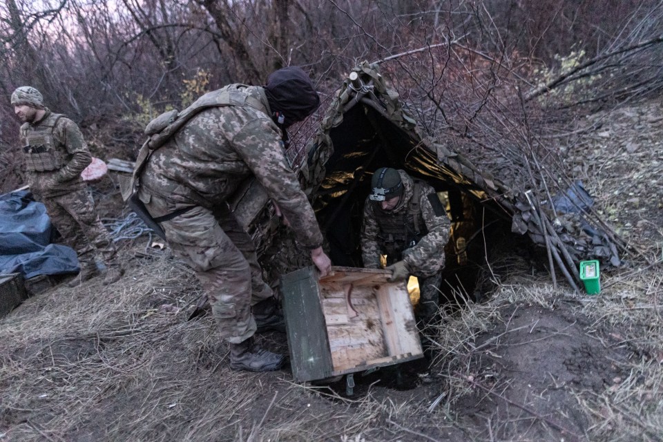 Ukrainian soldiers await orders at their fighting position in the direction of Bakhmut in Donetsk Oblast, Ukraine