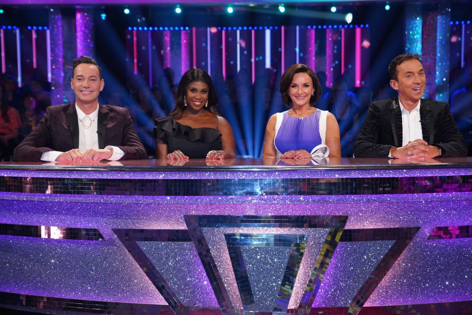 a group of people sitting at a table with a purple background