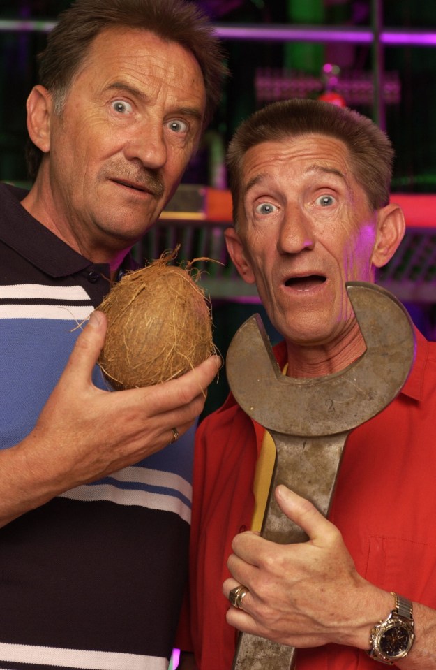 two men are holding a coconut and a wrench