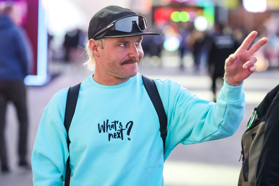 a man wearing a blue shirt that says what 's next