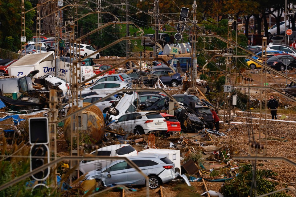 Vehicles are piled up on rail road tracks after heavy rains