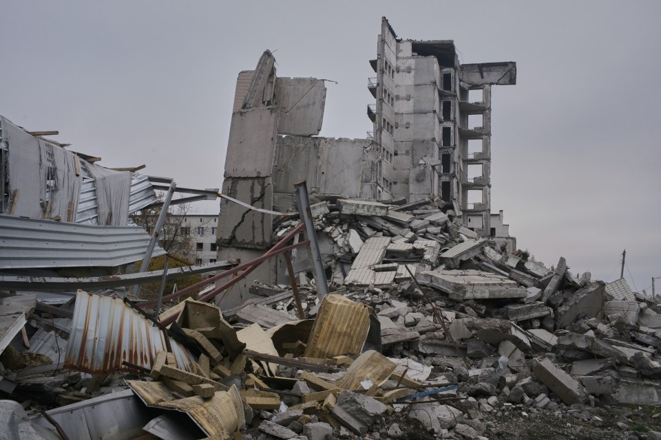 a pile of rubble with a building in the background