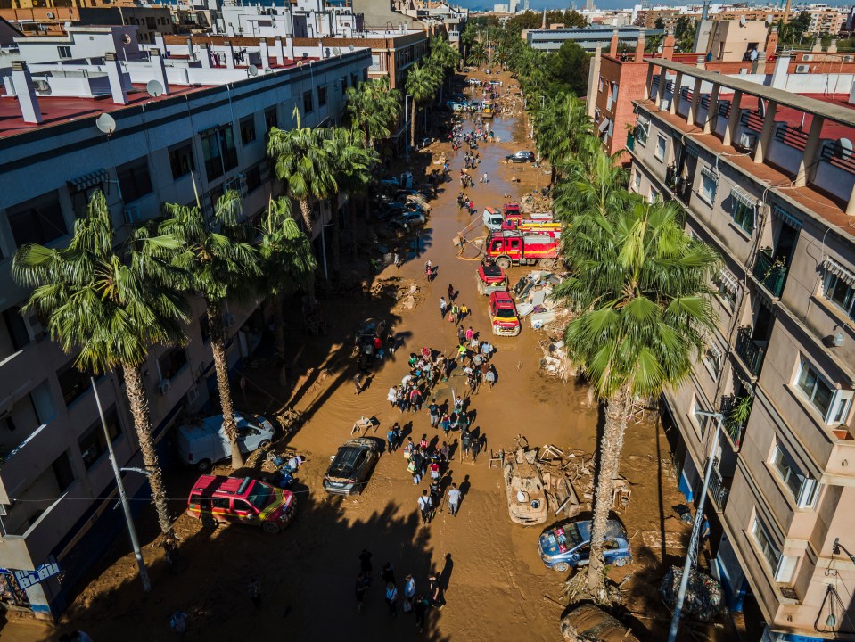 Volunteers and residents clean the mud four days after flash floods swept away everything in their path in Paiporta, outskirts of Valencia