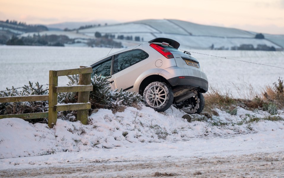 A car was seen upturned as the first snow of the year blanketed parts of Scotland