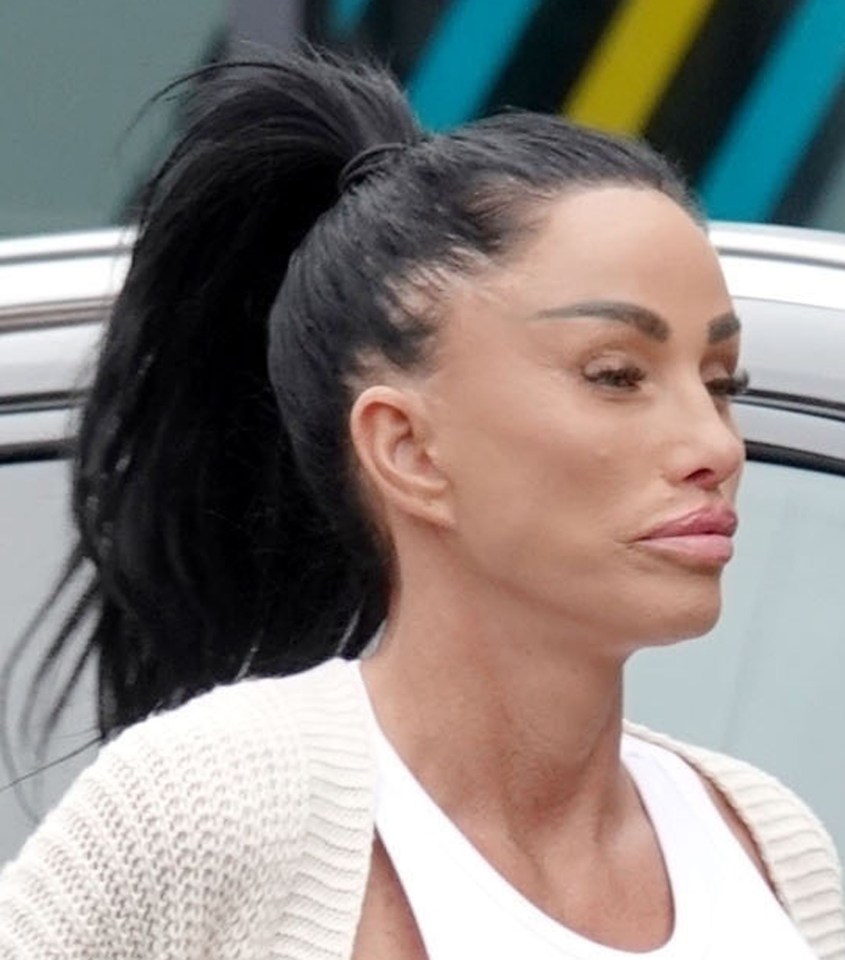 a close up of a woman 's face with a ponytail .