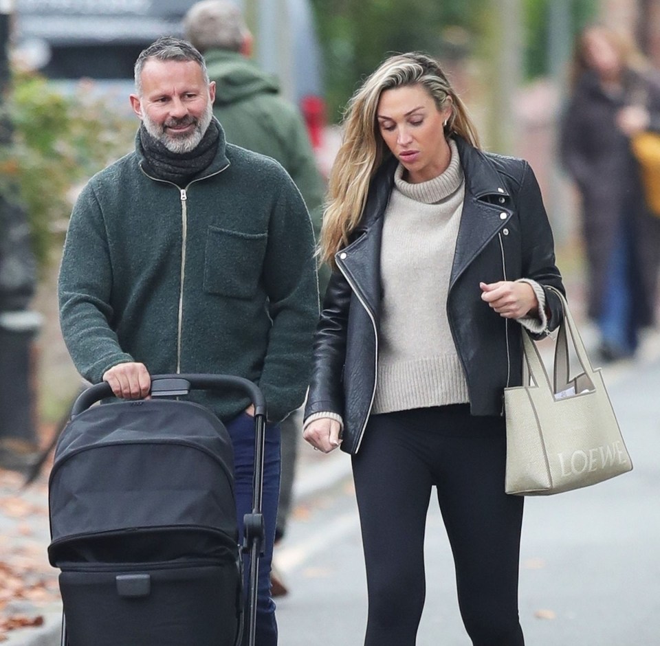 Giggs pushing his new baby girl in a pram alongside his girlfriend Zara Charles