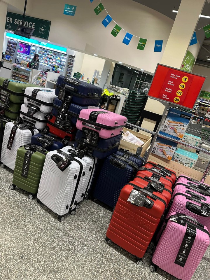 a bunch of suitcases are lined up in a store under a sign that says customer service