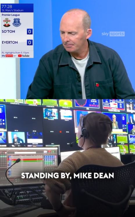 a man with a headset is standing by mike dean