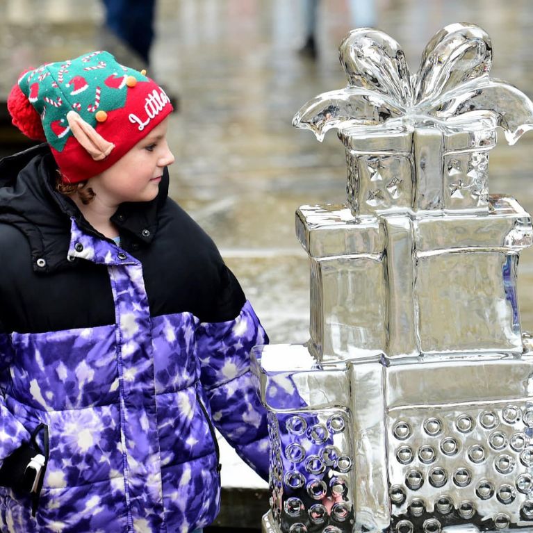 a little girl wearing a hat that says i little