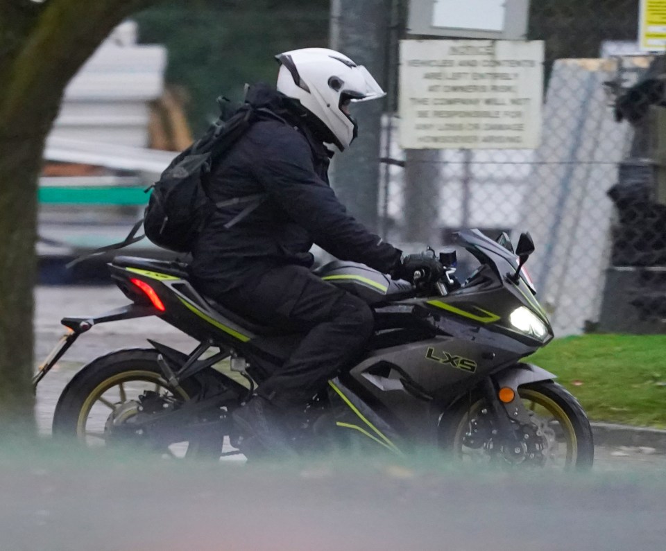 a person riding a motorcycle with the word lxs on it