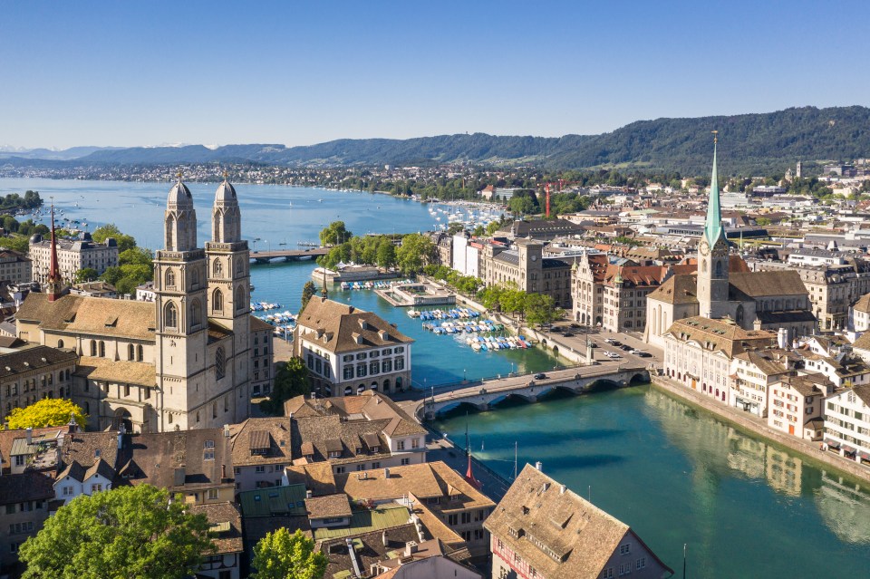 an aerial view of a city with a lake in the background