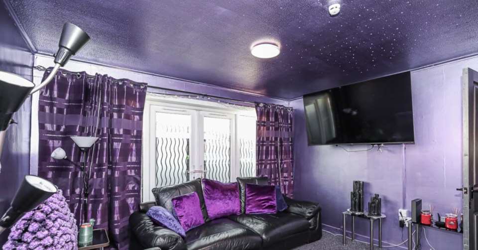 The living room walls have been covered with metallic purple paint