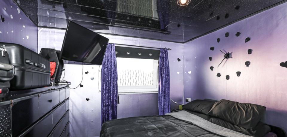 The bedroom has been decorated with purple and black