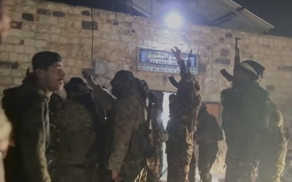 Syrian rebels celebrating their victory in Hama