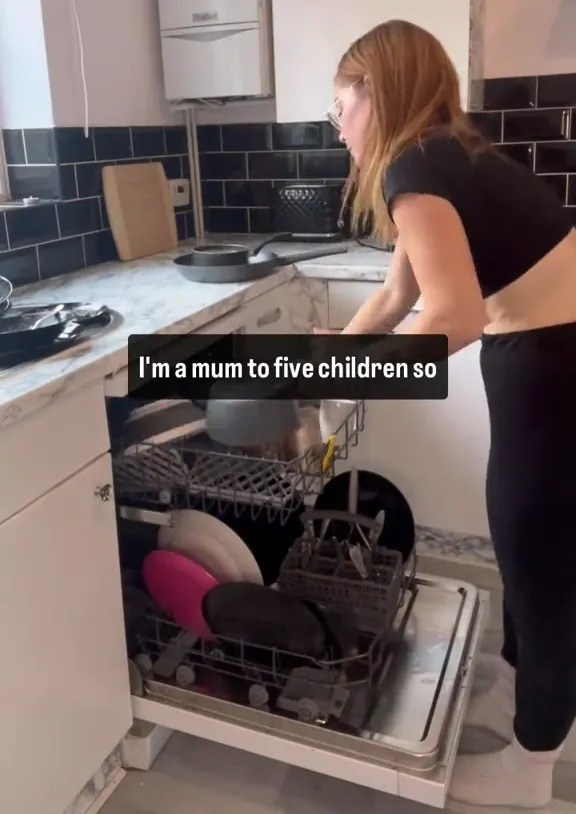 A mother of five loading a dishwasher.