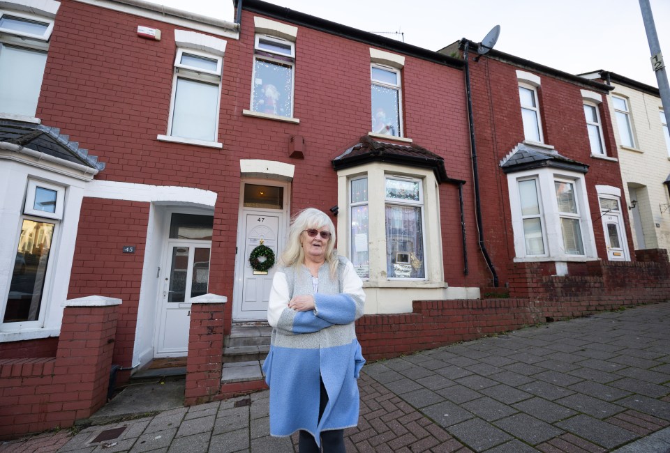 A woman stands outside the house used as Stacey's home in the TV show Gavin & Stacey.