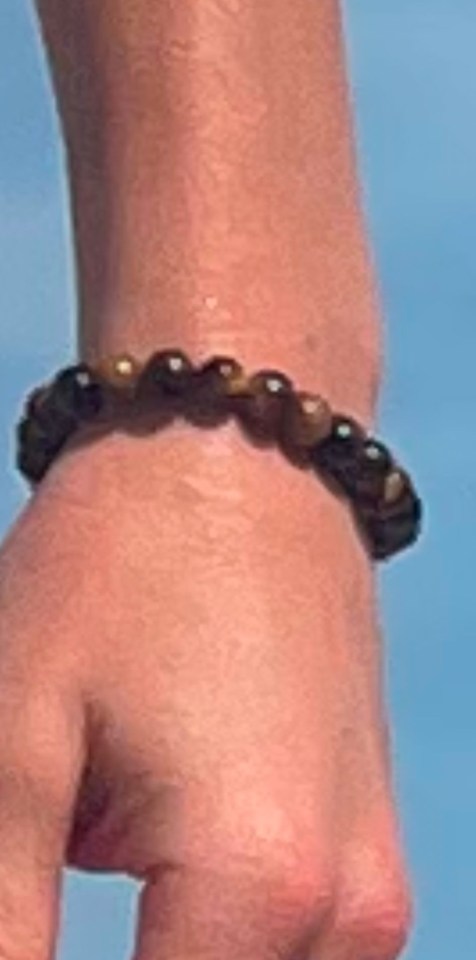 Close-up of a person's wrist wearing a beaded bracelet.