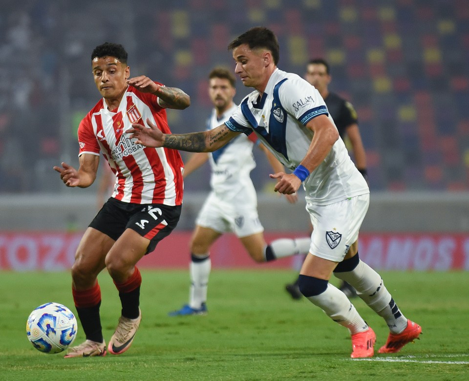 Soccer players battling for possession of the ball.