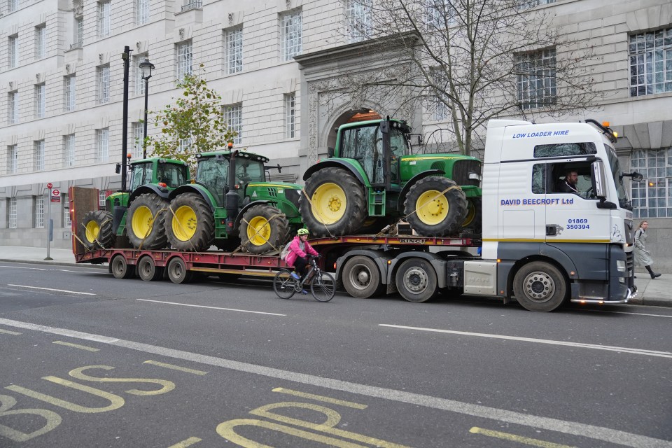 A transporter carrying tractors on Millbank in Westminster