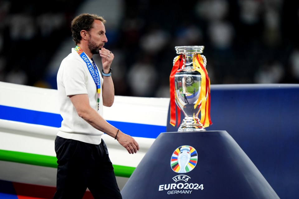 Gareth Southgate walks past the UEFA Euro 2024 trophy.