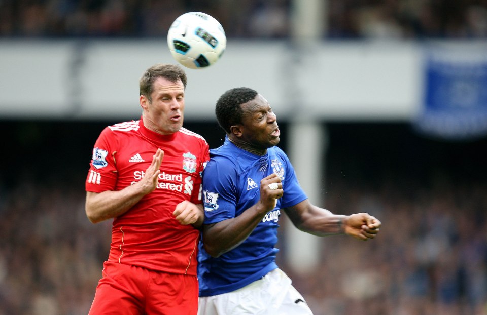 Everton's Yakubu and Liverpool's Jamie Carragher vying for the ball.