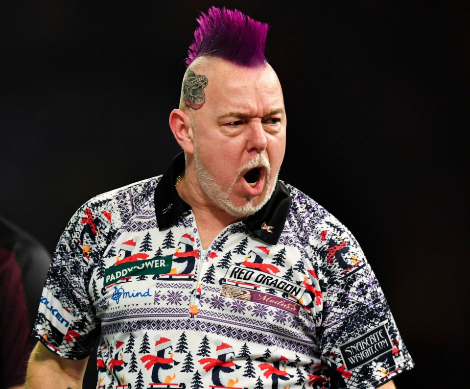 Peter Wright celebrates a darts match victory.