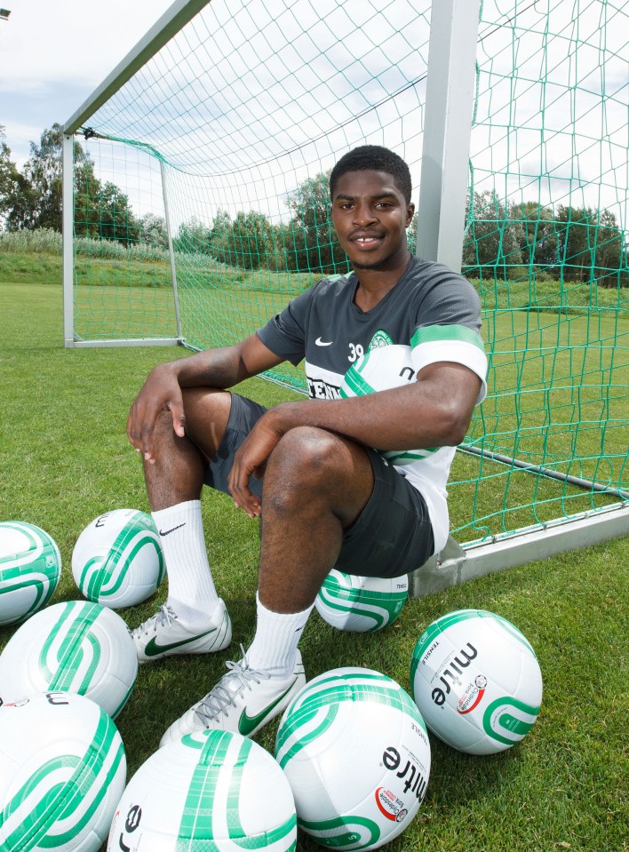 Celtic footballer sitting by soccer goal with soccer balls.