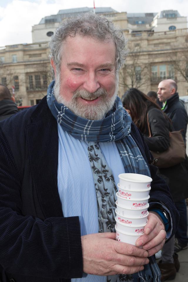 Actor Paul Bradley holding several cups of tea for charity.