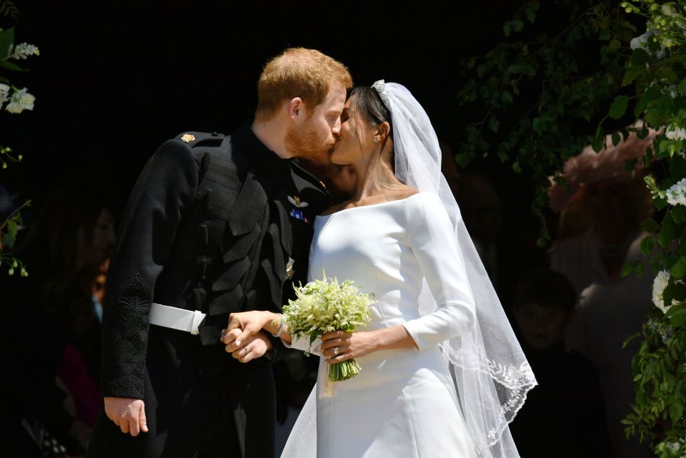 The couple share a kiss after tying the knot