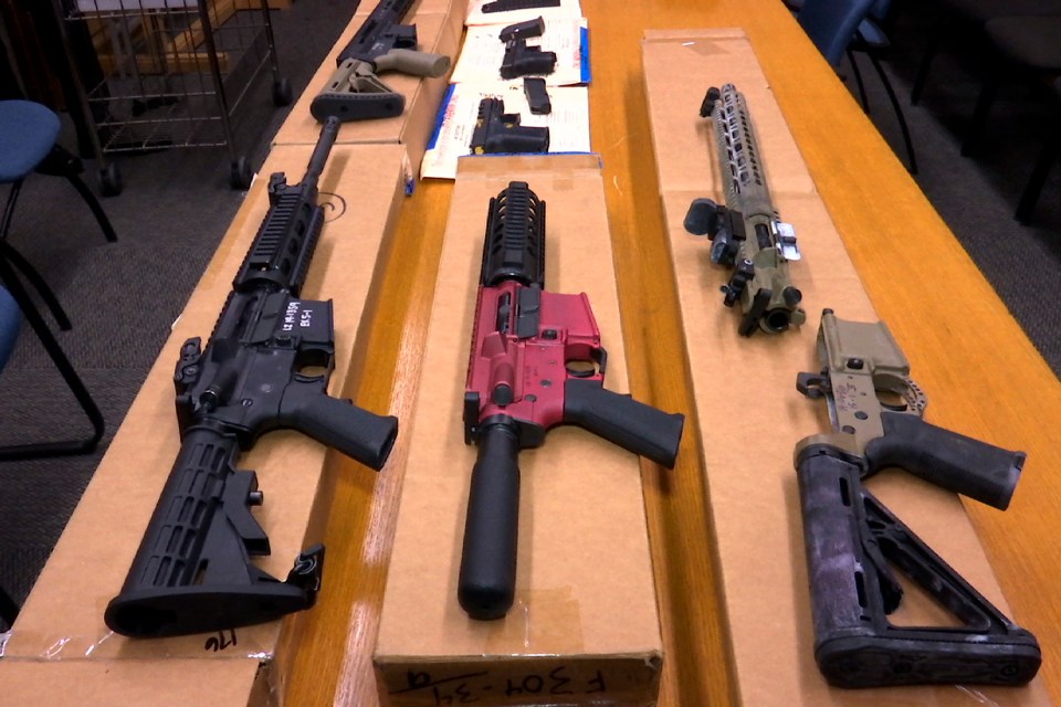 Several disassembled ghost guns on a table.