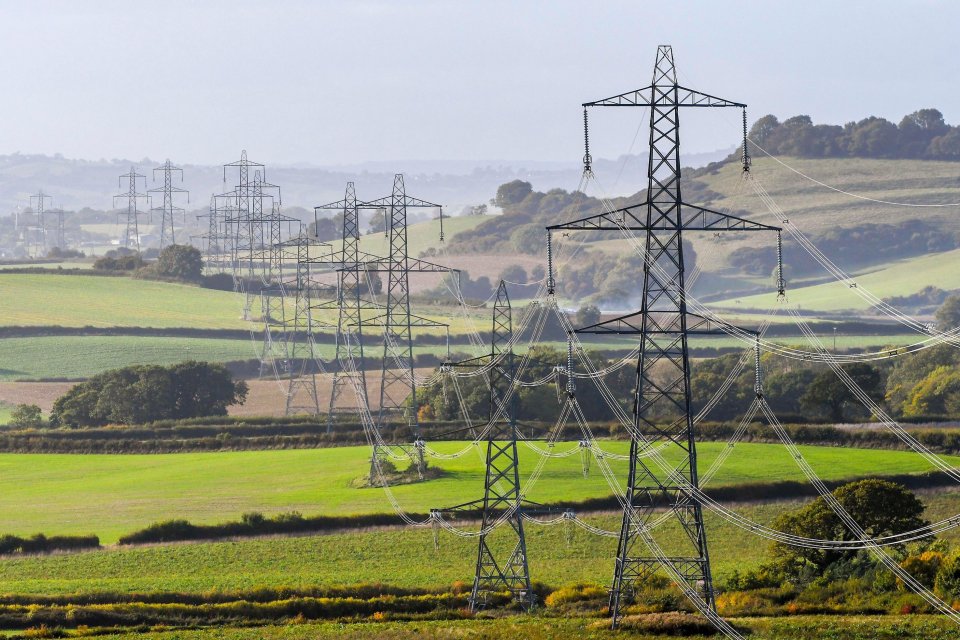 National Grid electricity pylons and power lines in a rural landscape.