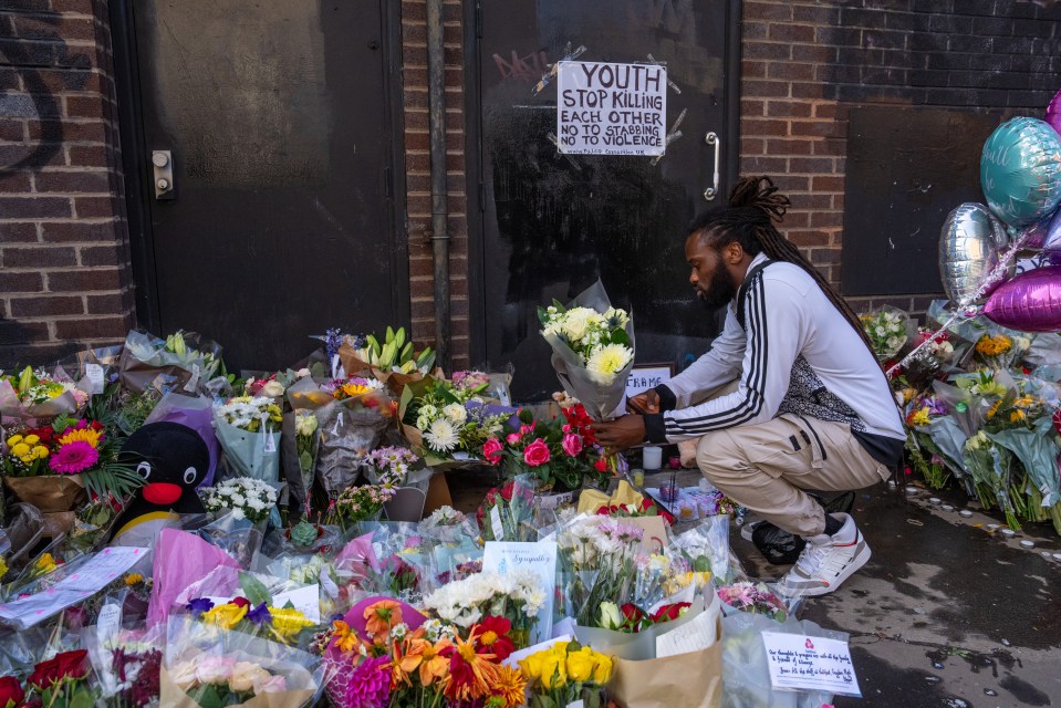 A man lays flowers at the scene of Elianne alleged murder