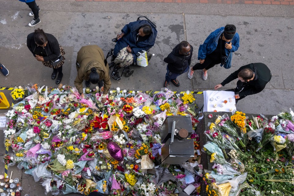 Mourners laid flowers around the scene of the fatal stabbing