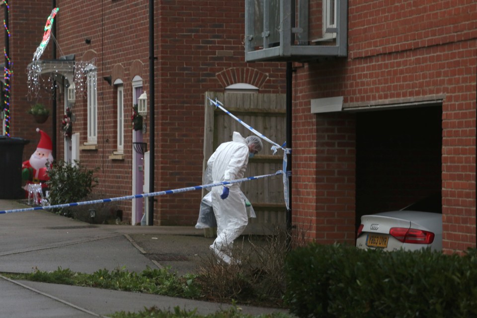 A forensics officer is seen entering a property on Friday