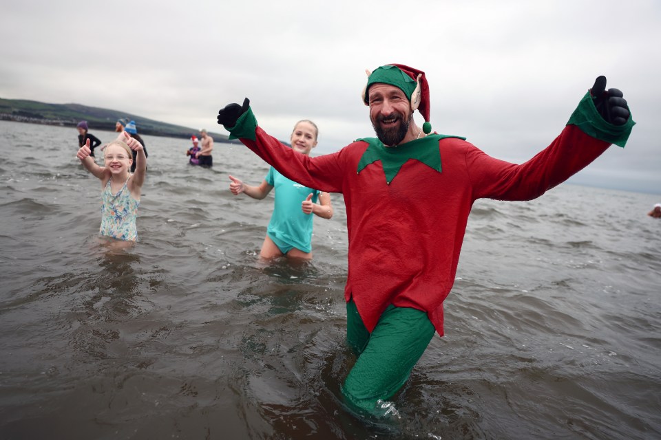 One family man headed into the water dressed as an elf