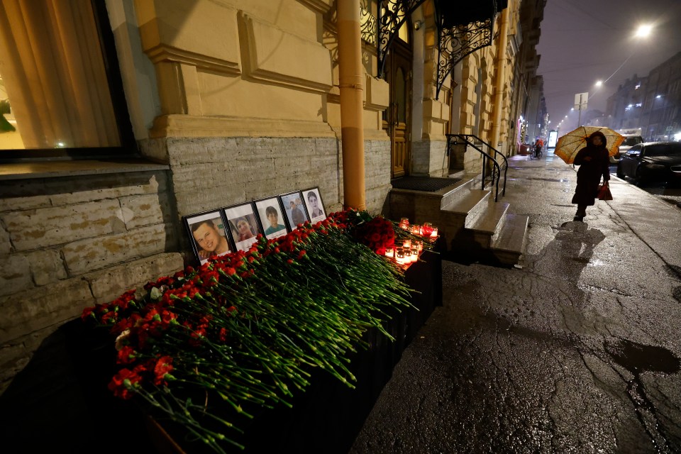 Candles, flowers, and portraits are placed in memory of those who died aboard the flight