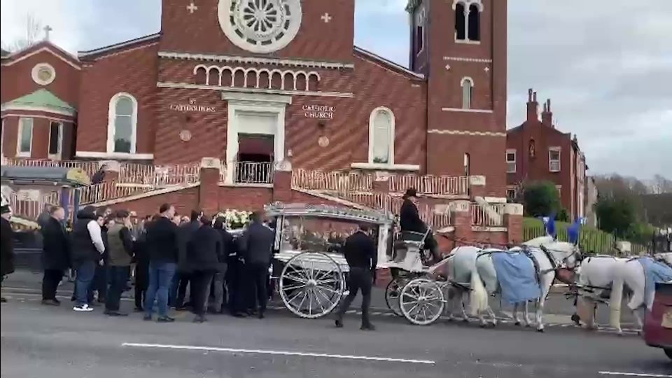 Michael's coffin being unloaded from the horse-drawn carriage