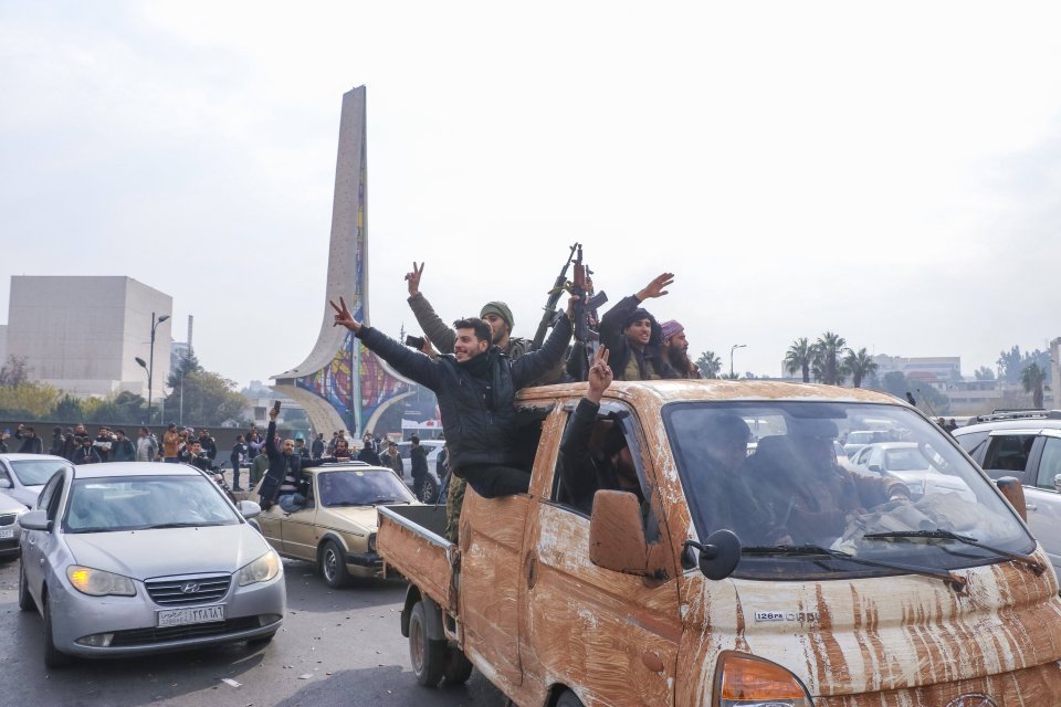 Rebel fighters parade in Damascus after their victory