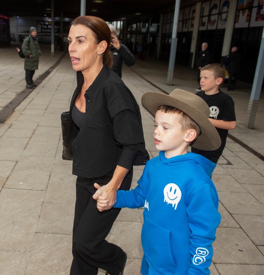 Coleen Rooney landed at Manchester Airport alongside two of her sons