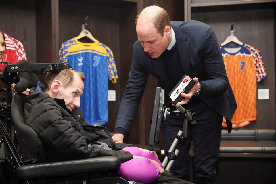 Wills presenting Rob with a CBE in January