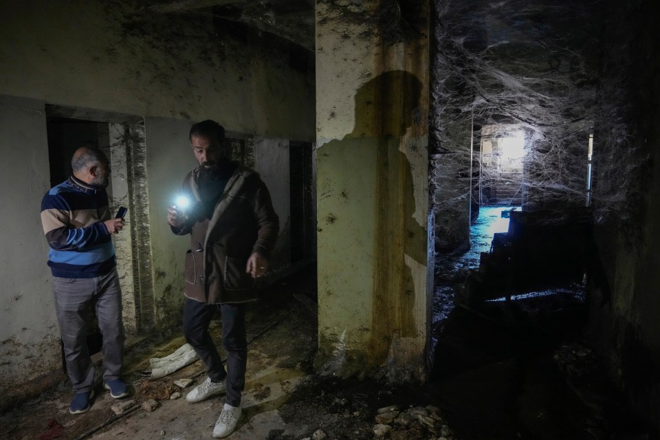 Men searching the barbaric Sednaya Military Prison today