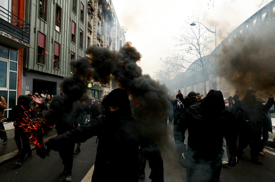 Tensions flare as wage-row campaigners let off smoke bombs in Paris on Thursday